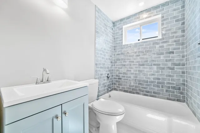 a bathroom with a sink a toilet and bathtub