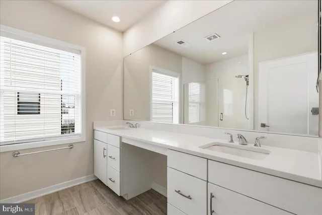 a bathroom with a sink double vanity and a window