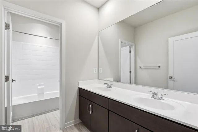 a bathroom with a double vanity sink mirror and double