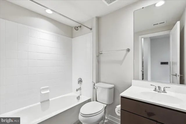 a bathroom with a sink a toilet a mirror and a bathtub