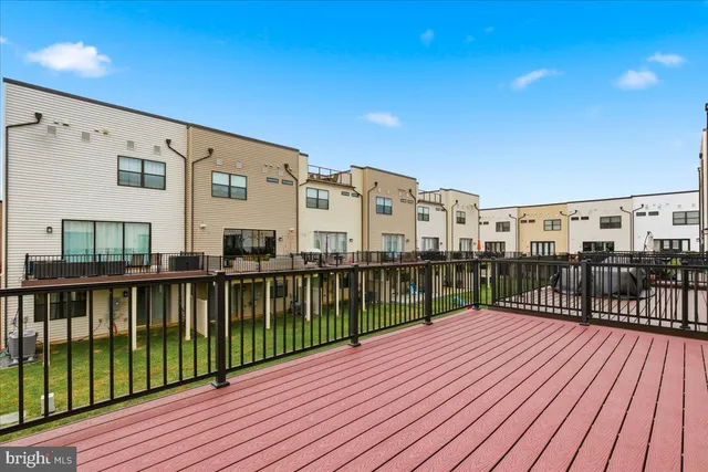 a view of a house with a wooden deck
