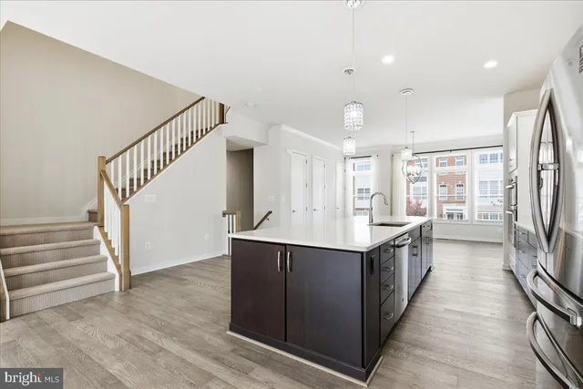 a kitchen with granite countertop a sink and a refrigerator