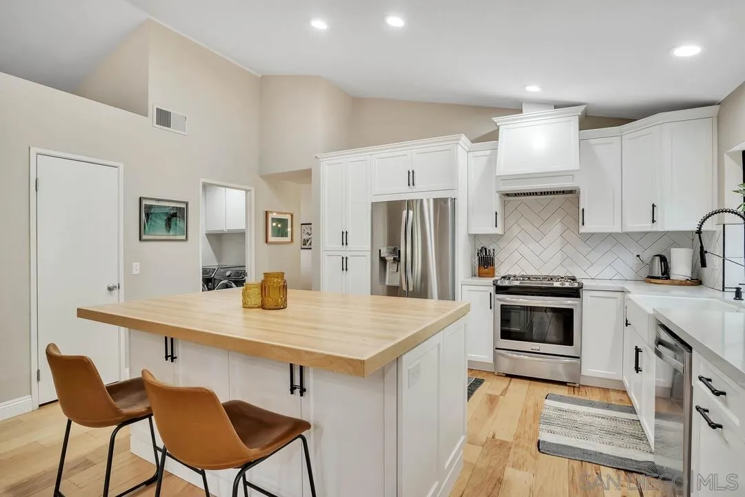 15867 Prairie Vista Road Poway, CA 92064 - Photo 17 of 70 a kitchen with stainless steel appliances a sink and a refrigerator