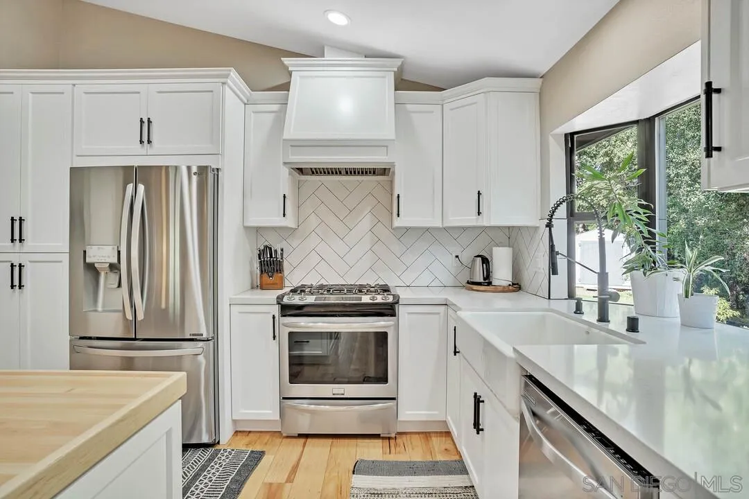 15867 Prairie Vista Road Poway, CA 92064 - Photo 18 of 70 a kitchen with stainless steel appliances granite countertop a stove a sink and a refrigerator