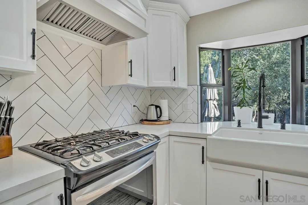 15867 Prairie Vista Road Poway, CA 92064 - Photo 21 of 70 a kitchen with a stove a sink and cabinets