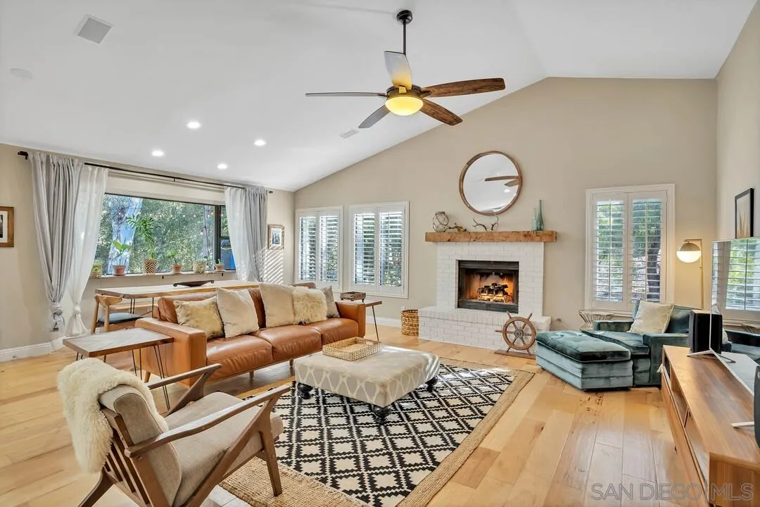 15867 Prairie Vista Road Poway, CA 92064 - Photo 25 of 70 a living room with furniture a fireplace and a large window