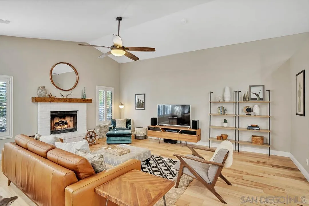 15867 Prairie Vista Road Poway, CA 92064 - Photo 28 of 70 a living room with furniture a fireplace and a flat screen tv