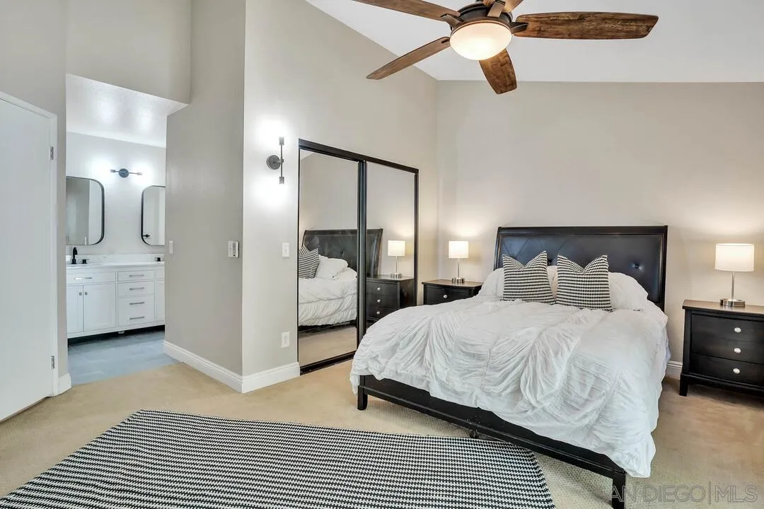 15867 Prairie Vista Road Poway, CA 92064 - Photo 32 of 70 a bedroom with a bed and a chandelier