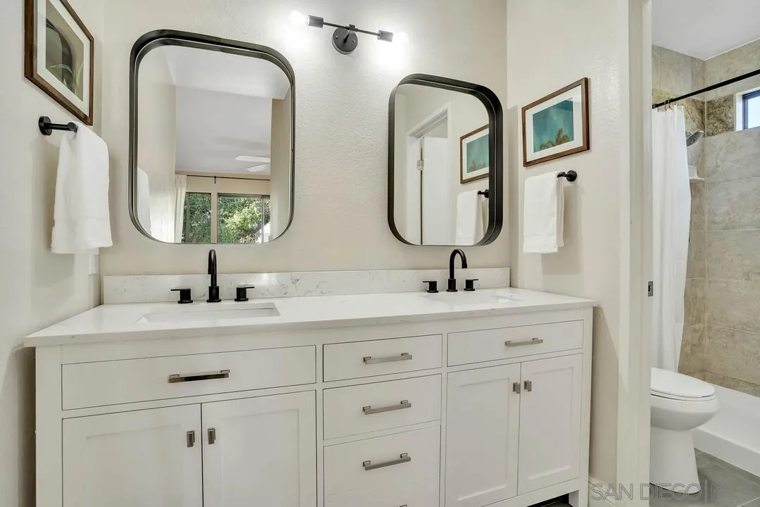 15867 Prairie Vista Road Poway, CA 92064 - Photo 34 of 70 a bathroom with a double vanity sink mirror and toilet