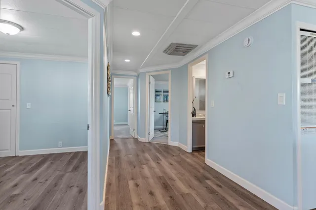 a view of hallway with wooden floor