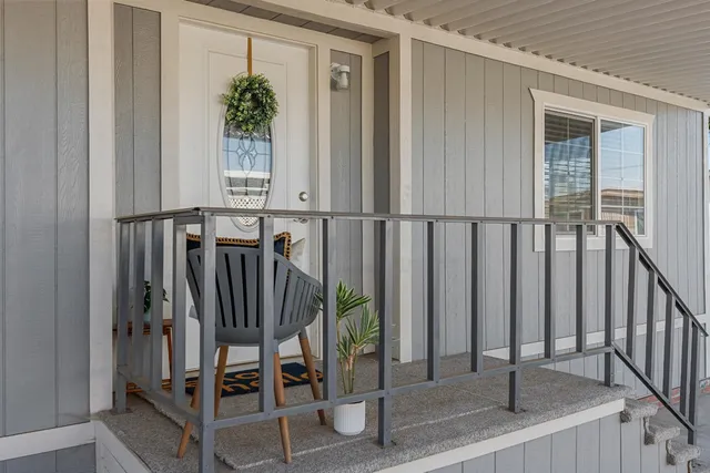 an entryway with a floor to ceiling window and stairs