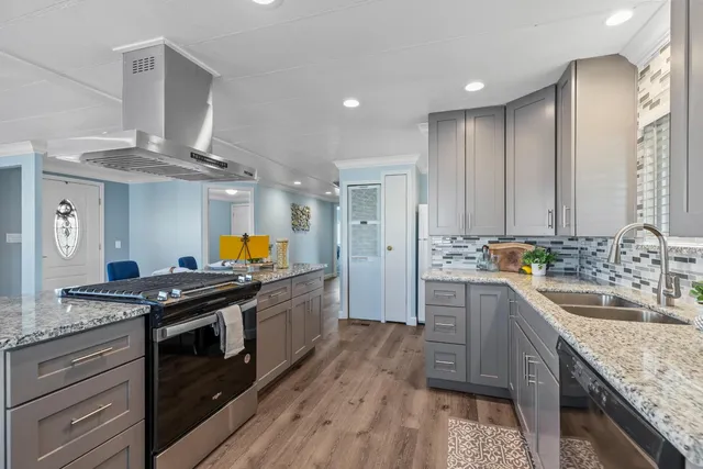 a kitchen with stainless steel appliances granite countertop a stove and a sink