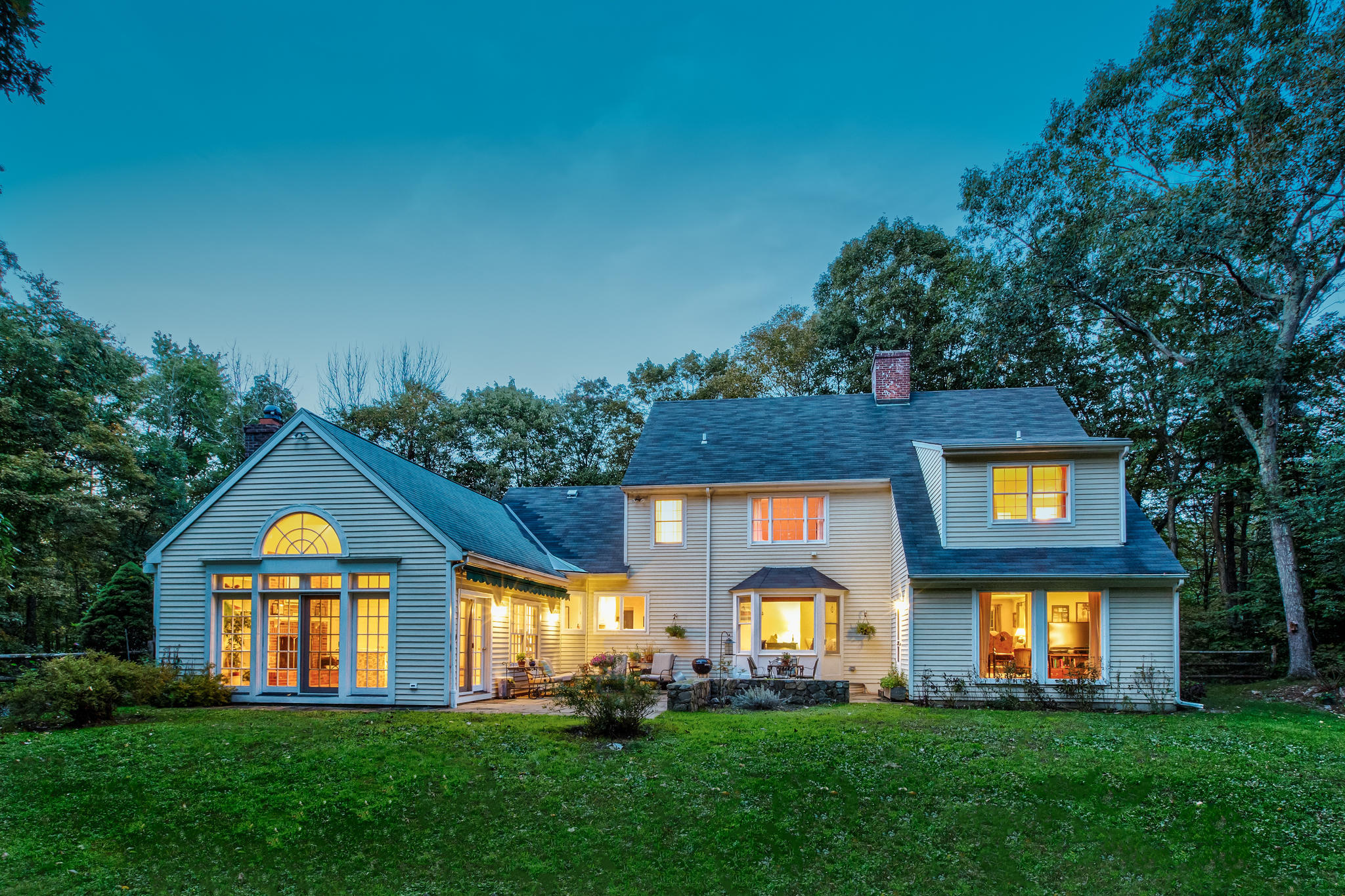 135 Mill Road New Canaan, CT 06840 - Photo 15 of 16 a front view of a house with a yard and garage