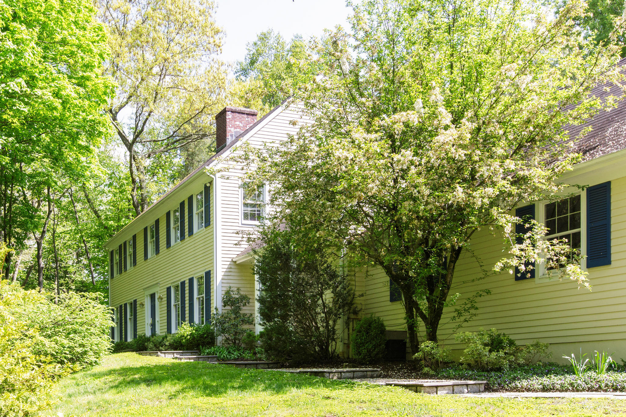 135 Mill Road New Canaan, CT 06840 - Photo 16 of 16 a view of a house with a tree in a yard
