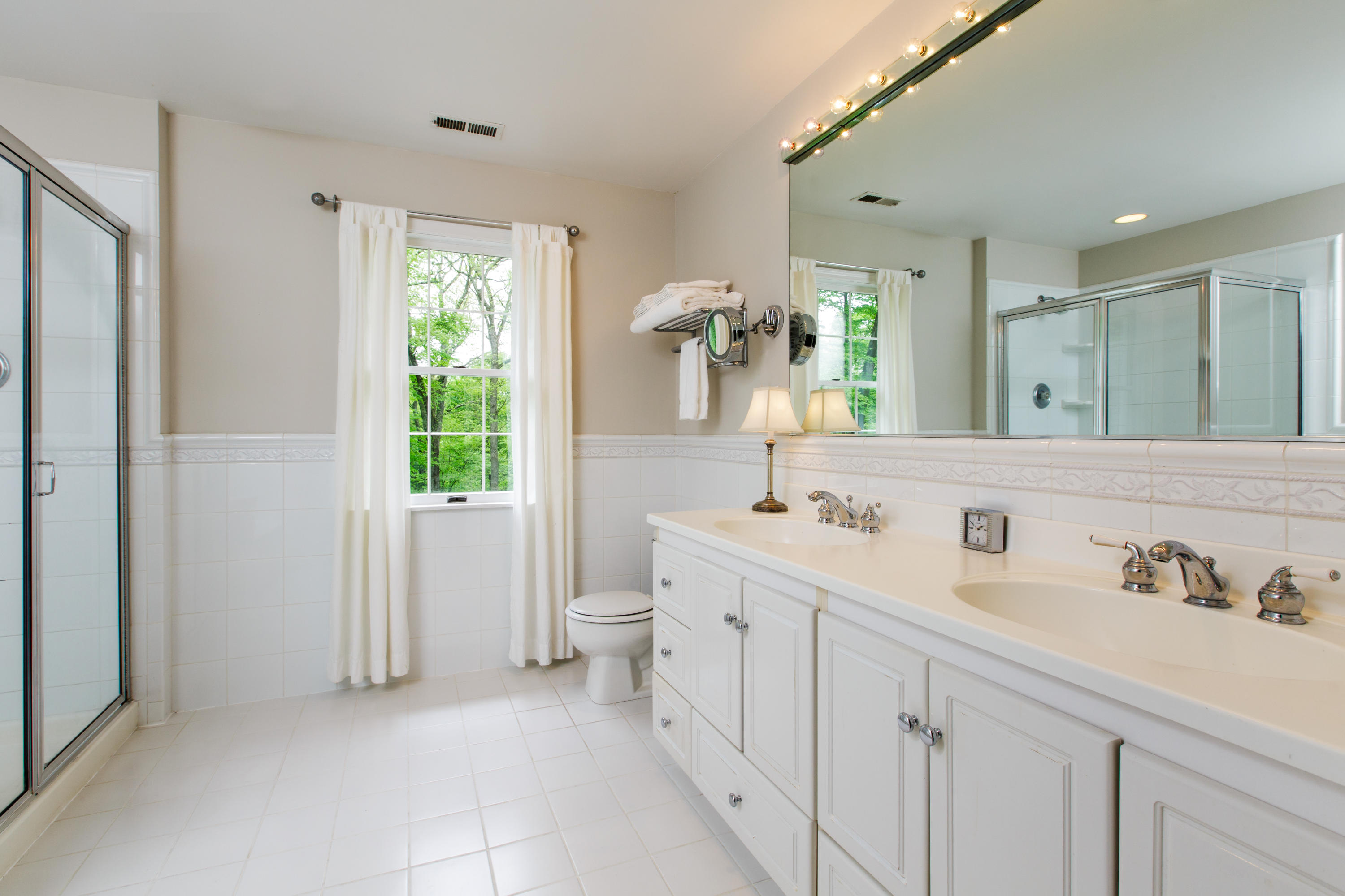 135 Mill Road New Canaan, CT 06840 - Photo 10 of 16 a bathroom with a sink and a mirror