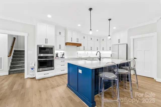 a view of a dining room with furniture and a chandelier
