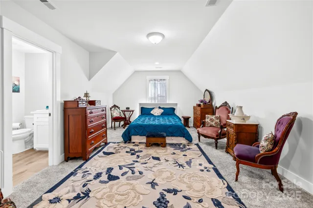 a bed room with furniture and a chandelier