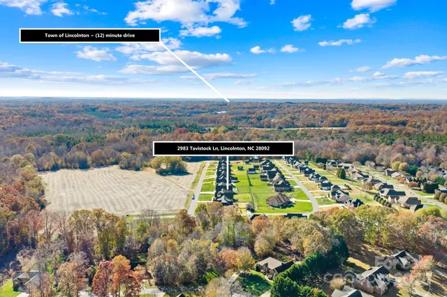 an aerial view of a house with swimming pool garden and patio