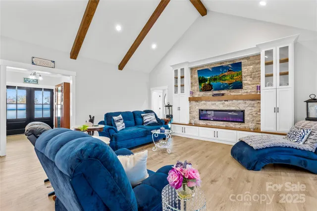 a kitchen that has a lot of cabinets in it and wooden floor