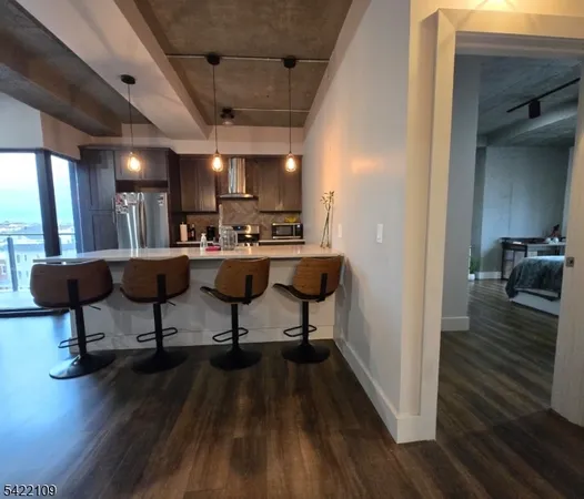 a view of a kitchen with dining table and wooden floor