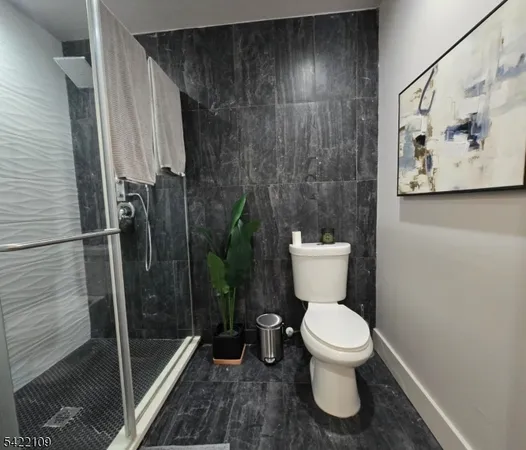 a bathroom with a toilet and a shower