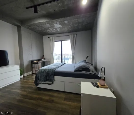 a bedroom with a bed and a night stand