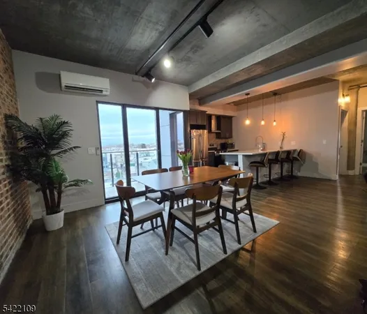 a dining room with furniture window and wooden floor