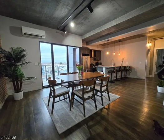 a dining room with furniture window and wooden floor