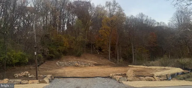 a view of a road with a yard of the house