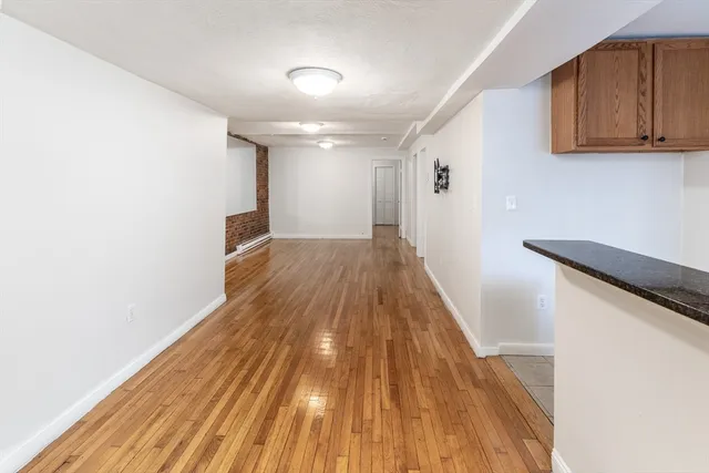 a view of a room with wooden floor and staircase
