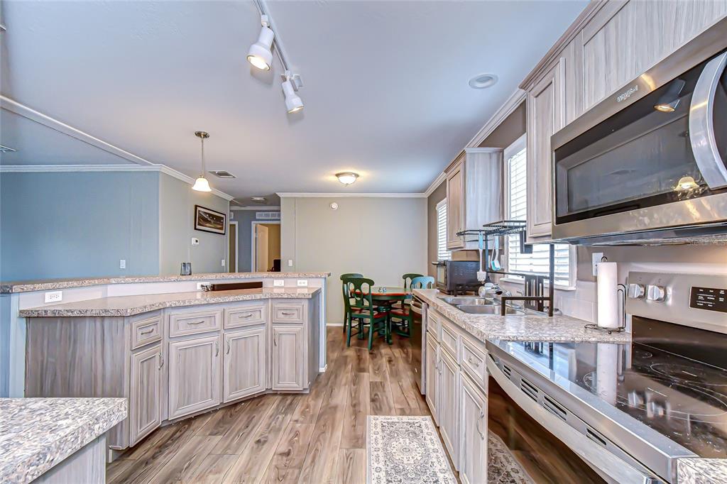 37749 Geiger Road Zephyrhills, FL 33542 - Photo 13 of 36 a kitchen with lots of counter top space and stainless steel appliances