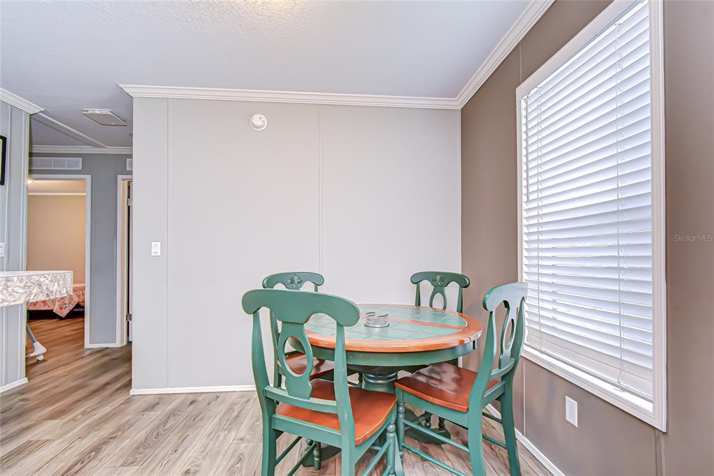 37749 Geiger Road Zephyrhills, FL 33542 - Photo 15 of 36 a view of a dining room with furniture and wooden floor