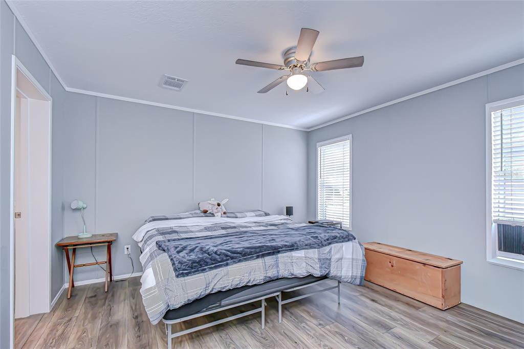 37749 Geiger Road Zephyrhills, FL 33542 - Photo 19 of 36 a bedroom with a bed and wooden floor