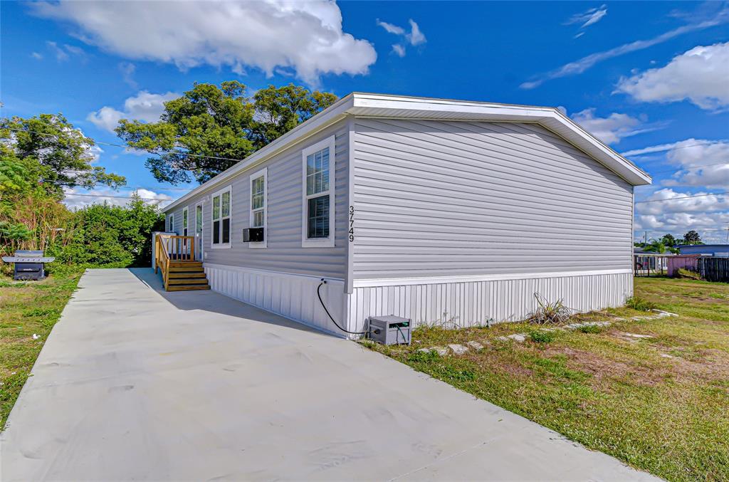 37749 Geiger Road Zephyrhills, FL 33542 - Photo 2 of 36 a front view of a house with garden