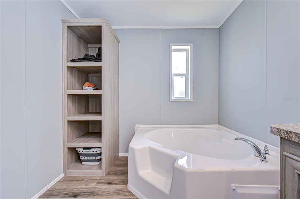37749 Geiger Road Zephyrhills, FL 33542 - Photo 23 of 36 a white bath tub sitting next to a window