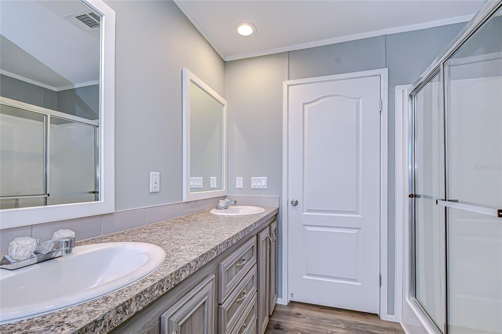 37749 Geiger Road Zephyrhills, FL 33542 - Photo 24 of 36 a bathroom with a granite countertop sink and a mirror