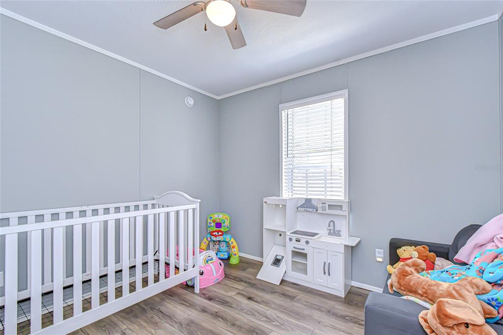 37749 Geiger Road Zephyrhills, FL 33542 - Photo 29 of 36 a bedroom with a bed and a window