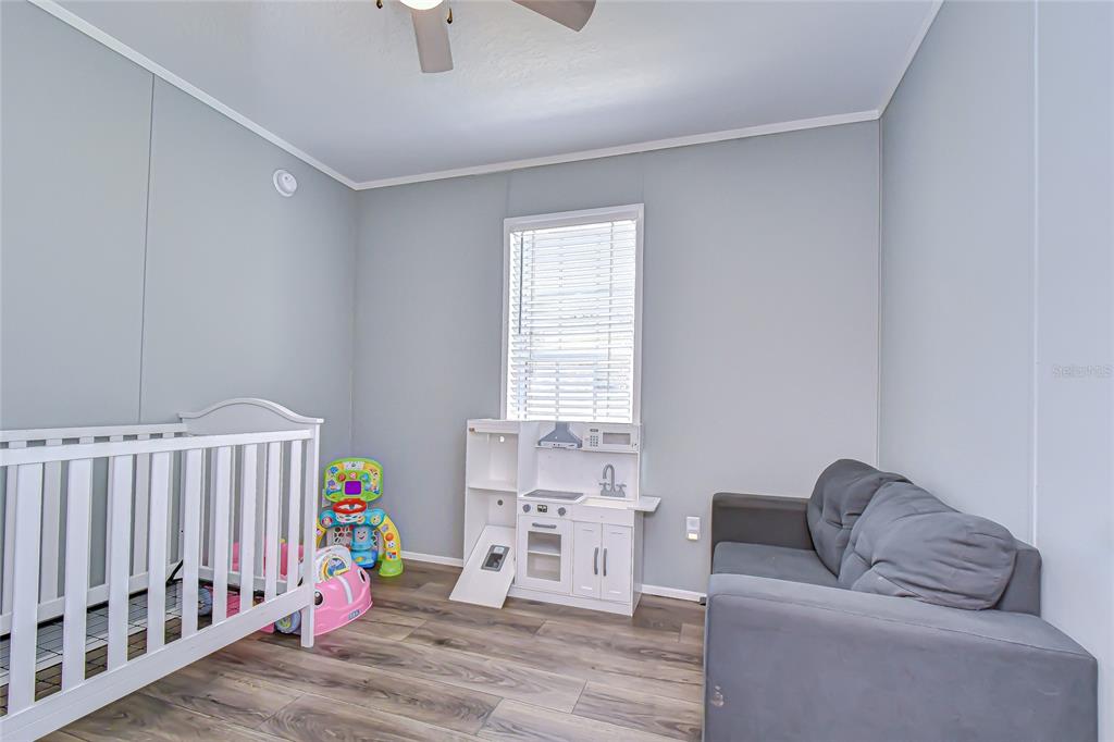 37749 Geiger Road Zephyrhills, FL 33542 - Photo 30 of 36 a bedroom with furniture and a window