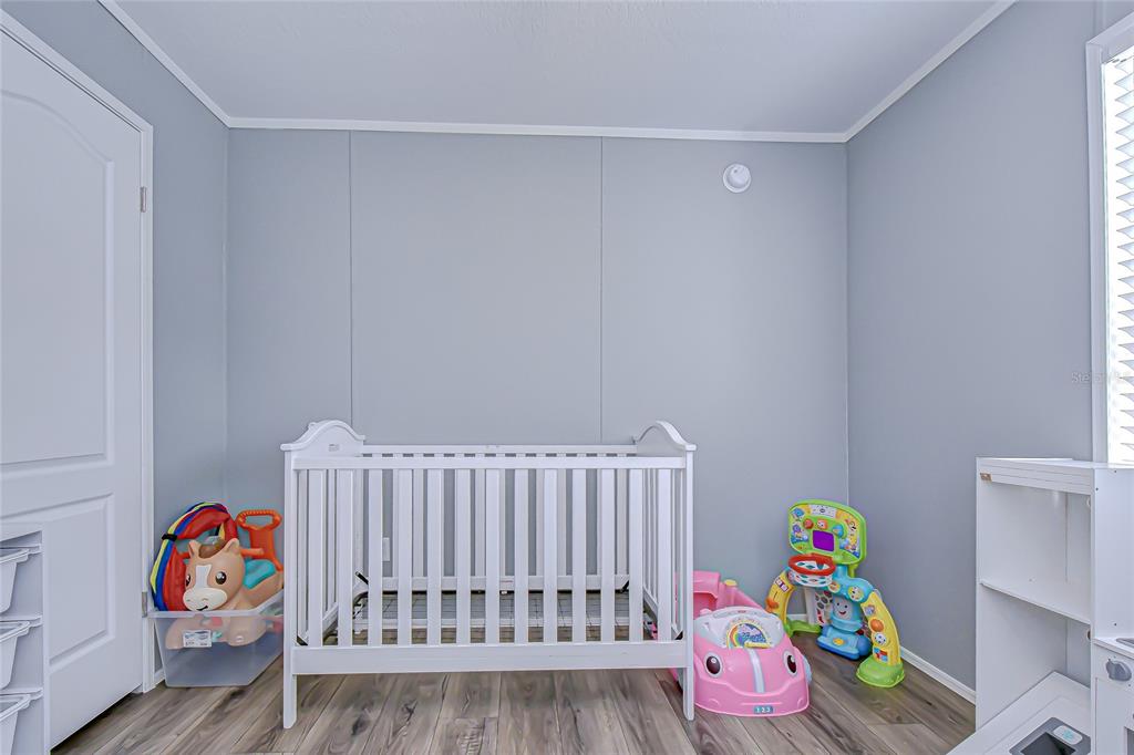 37749 Geiger Road Zephyrhills, FL 33542 - Photo 31 of 36 a bedroom with a bed and a window