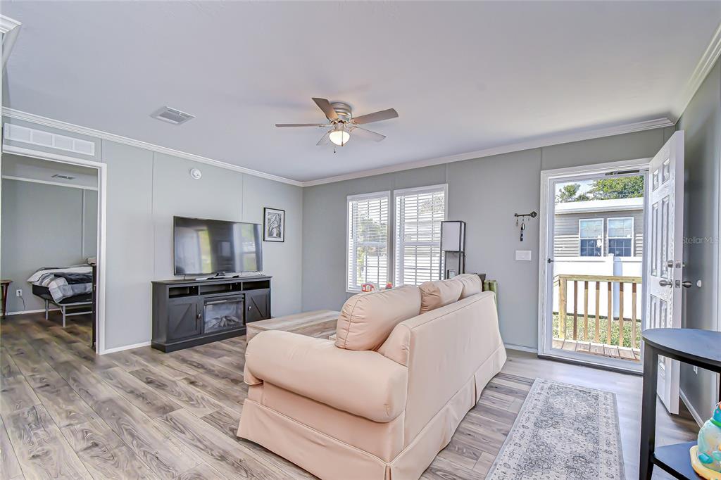 37749 Geiger Road Zephyrhills, FL 33542 - Photo 4 of 36 a living room with furniture fireplace and a flat screen tv
