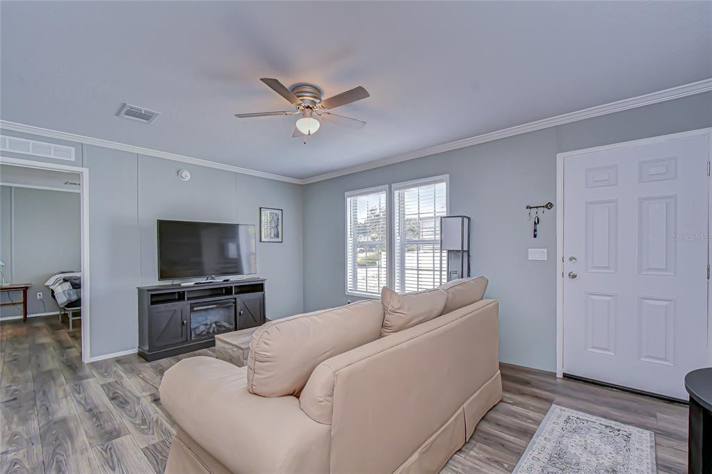 37749 Geiger Road Zephyrhills, FL 33542 - Photo 5 of 36 a bed room with a bed a television and dresser
