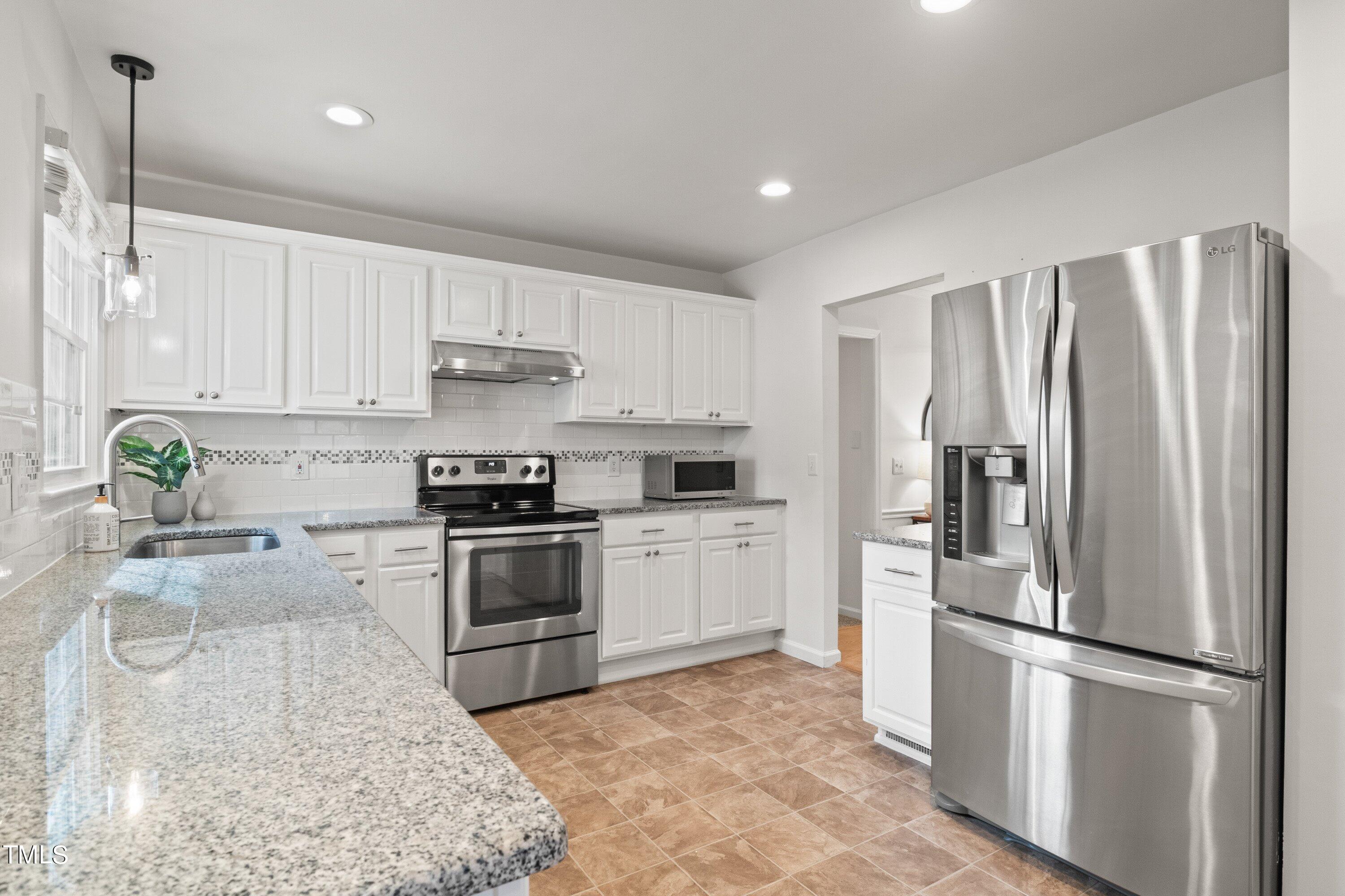 1 Kellom Court Durham, NC 27713 - Photo 18 of 33 a kitchen with a refrigerator and a stove top oven