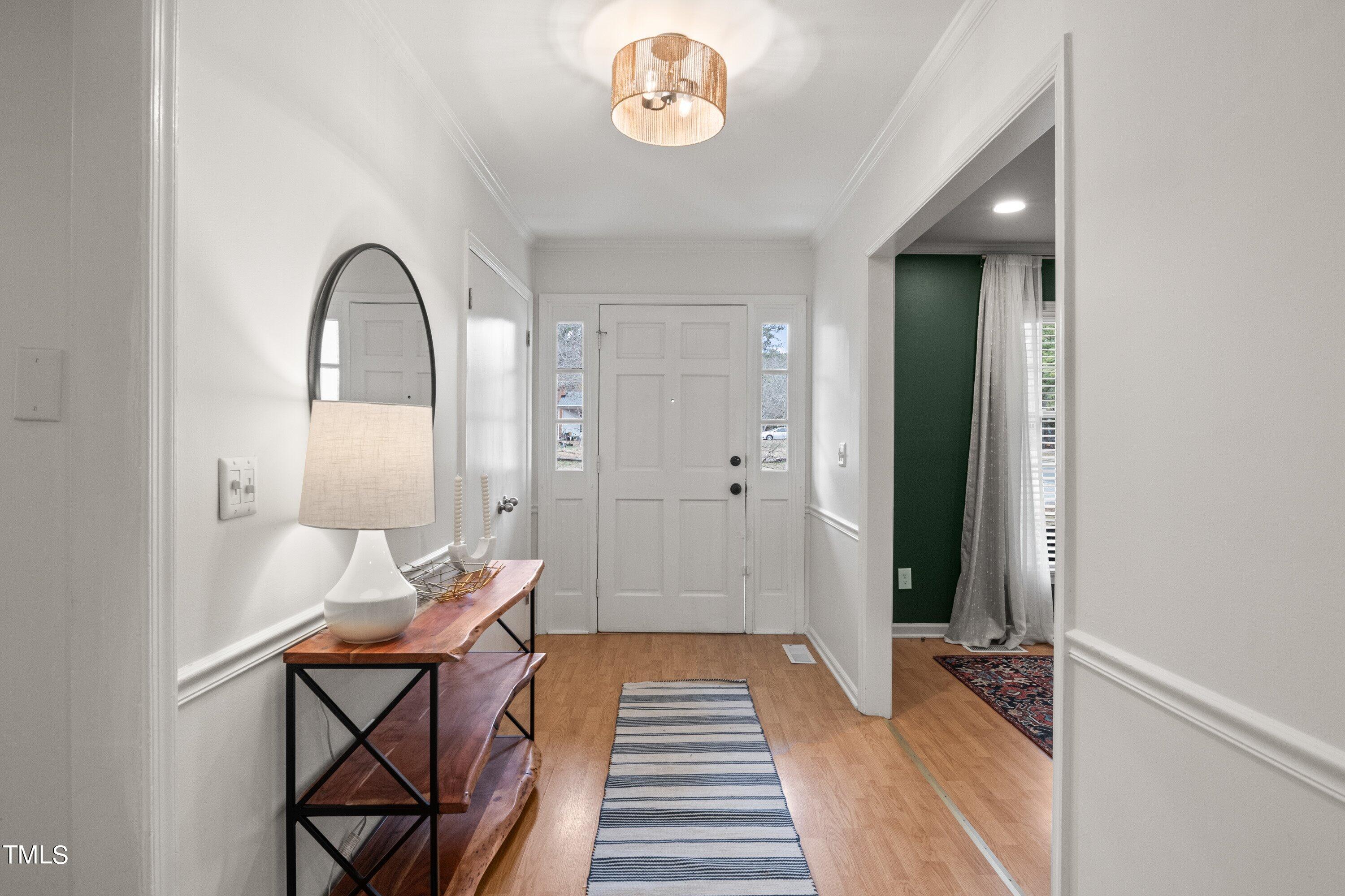 1 Kellom Court Durham, NC 27713 - Photo 9 of 33 a hallway with a dining table and chairs