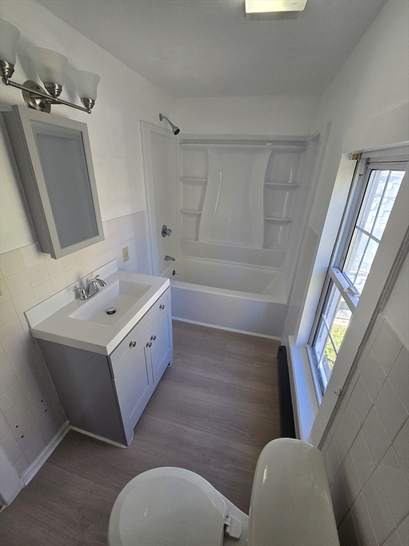 176 Green Street, Unit 2 Brockton, MA 02301 - Photo 14 of 15 a bathroom with a double vanity sink toilet a tub and shower