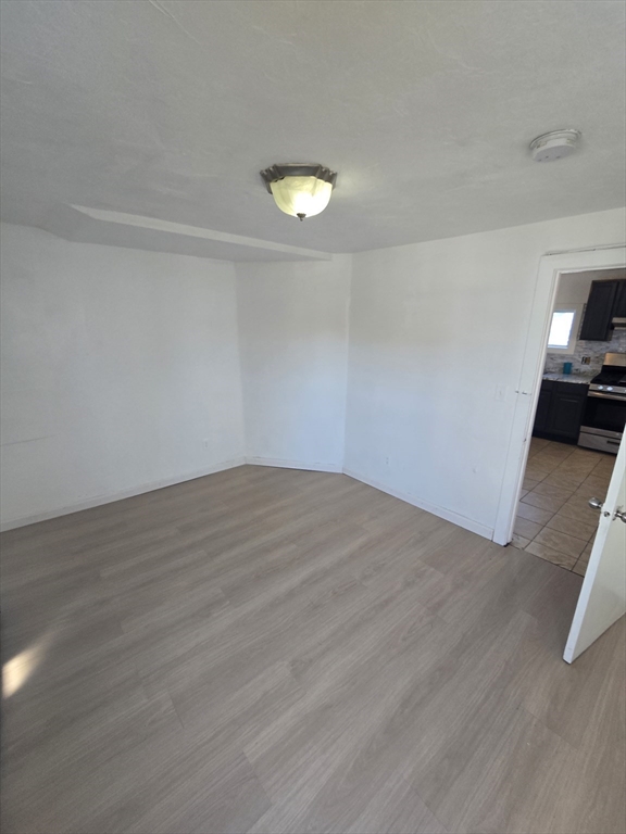 176 Green Street, Unit 2 Brockton, MA 02301 - Photo 6 of 15 a view of empty room with wooden floor