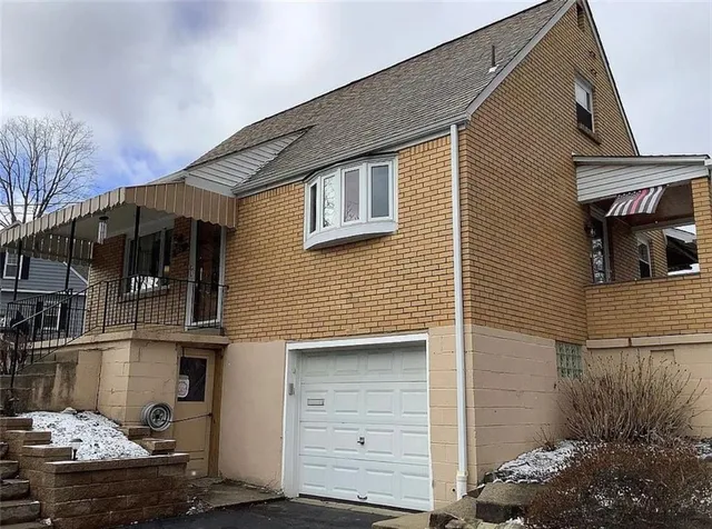 a front view of a house with a garage