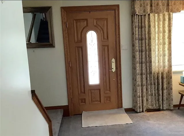 a view of a livingroom with wooden floor and a window