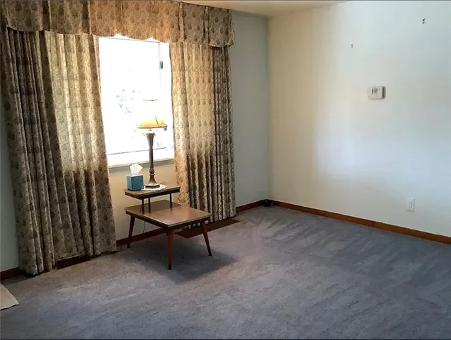 a room that has a bench and a window