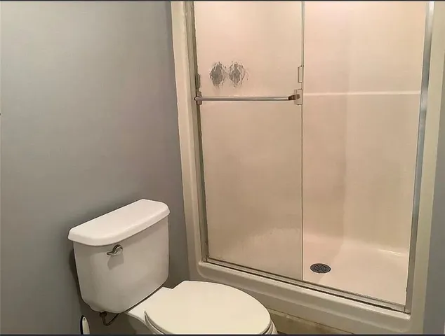 a white toilet sitting next to a bathroom sink