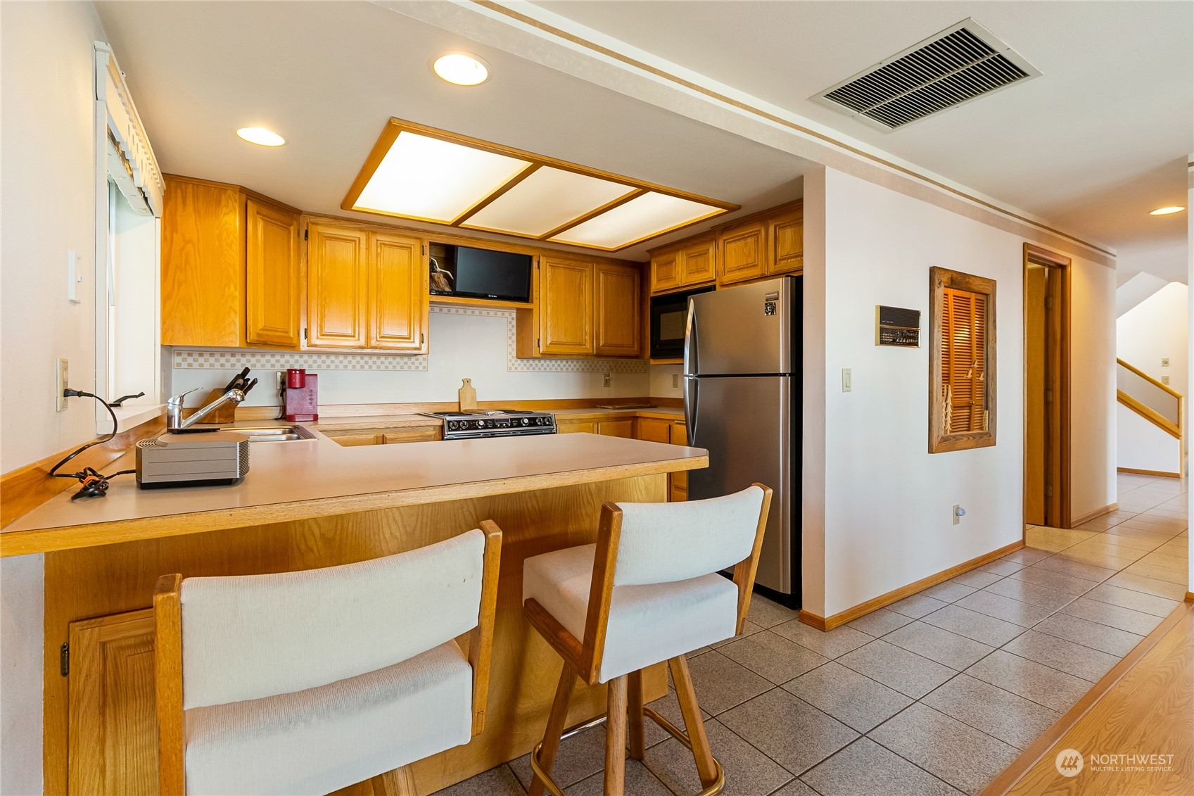 3376 Northgate Road Bellingham, WA 98226 - Photo 14 of 38 a kitchen with a table chairs refrigerator and a sink